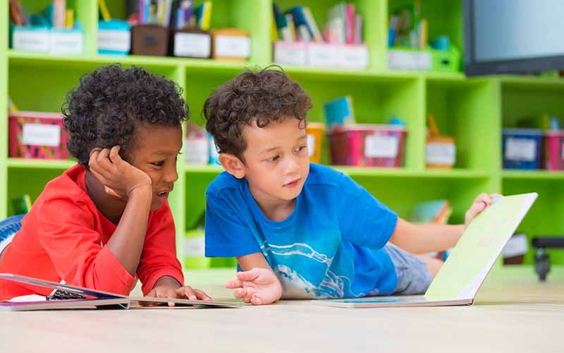 Boys reading together