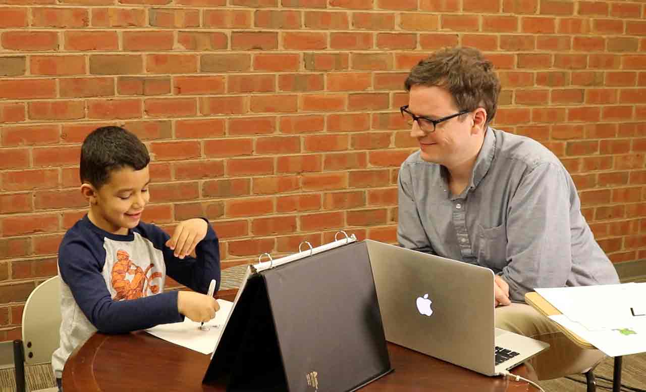 Student taking a math assessment with teacher