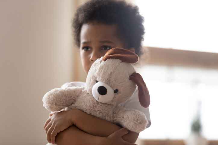 Boy hugging bear